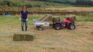 gathering hay with quad bike adrian