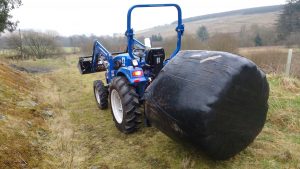 haylage bale on tractor
