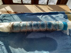 rolling the wetted down fibres
